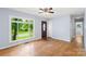 Bright living room featuring hardwood floors, neutral walls, a ceiling fan, and a large window at 1075 Parkview Dr, Gastonia, NC 28054