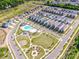 Aerial view of a Primary-planned community featuring pool, green spaces, playgrounds, and neatly arranged homes at 11951 Old Statesville Rd, Huntersville, NC 28078