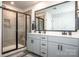 Contemporary bathroom with double vanity, sleek mirror, and glass-enclosed shower at 11951 Old Statesville Rd, Huntersville, NC 28078