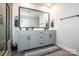 Clean bathroom showcases a double vanity, frameless mirror, and walk-in shower at 11951 Old Statesville Rd, Huntersville, NC 28078