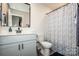 Stylish bathroom featuring a shower with patterned curtain, modern vanity, and sleek fixtures at 11951 Old Statesville Rd, Huntersville, NC 28078