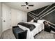 Well-lit bedroom features a modern accent wall, ceiling fan, and plush carpet at 11951 Old Statesville Rd, Huntersville, NC 28078