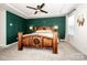 Bedroom features a wooden bed frame, decorative green wall panel, and neutral tones at 11951 Old Statesville Rd, Huntersville, NC 28078