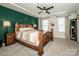 Cozy bedroom with a wooden bed frame, decorative wall panel, and neutral tones at 11951 Old Statesville Rd, Huntersville, NC 28078