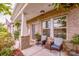 Cozy front porch featuring brick columns, seating, and ample natural light at 11951 Old Statesville Rd, Huntersville, NC 28078