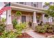 Inviting front porch with brick columns, charming decor, and well-maintained landscaping at 11951 Old Statesville Rd, Huntersville, NC 28078