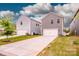 Two-car garages with driveways and green lawns at 11951 Old Statesville Rd, Huntersville, NC 28078