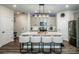 Modern kitchen boasts an island with seating, stainless steel appliances, and stylish lighting at 11951 Old Statesville Rd, Huntersville, NC 28078