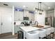 Well-equipped kitchen featuring a quartz countertop island with seating, stainless appliances, and modern finishes at 11951 Old Statesville Rd, Huntersville, NC 28078