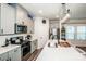 Modern kitchen with a large island, stainless steel appliances, and overhead lighting at 11951 Old Statesville Rd, Huntersville, NC 28078
