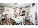 Well-lit kitchen with a large island and seating, ample cabinet space, and stainless steel refrigerator at 11951 Old Statesville Rd, Huntersville, NC 28078