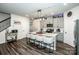 Stylish kitchen featuring a large island with seating, modern fixtures, and wood-look flooring at 11951 Old Statesville Rd, Huntersville, NC 28078
