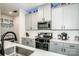 Modern kitchen featuring stainless steel appliances, ample counter space, and white backsplash at 11951 Old Statesville Rd, Huntersville, NC 28078