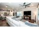Open-concept living room with hardwood floors, modern ceiling fan, and seamless flow to the kitchen at 11951 Old Statesville Rd, Huntersville, NC 28078