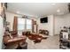 Cozy living room featuring a leather sofa, decorative rug, and mounted television at 11951 Old Statesville Rd, Huntersville, NC 28078