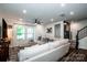 Comfortable living room with a large sectional sofa, natural light, and staircase access at 11951 Old Statesville Rd, Huntersville, NC 28078