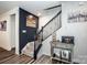 Stylish staircase with dark wood accents, carpeted steps, and decorative wall paneling at 11951 Old Statesville Rd, Huntersville, NC 28078