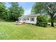 Home backyard featuring a deck, grassy yard, and mature trees at 1211 11Th Nw St, Hickory, NC 28601