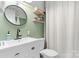Updated bathroom featuring a modern vanity, round mirror, and neutral decor at 1211 11Th Nw St, Hickory, NC 28601