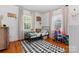 Playful bedroom featuring hardwood floors and two bright windows at 1211 11Th Nw St, Hickory, NC 28601