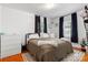 Bright bedroom with natural light, hardwood floors, and white dressers at 1211 11Th Nw St, Hickory, NC 28601