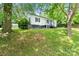 Side view of house with lots of landscaping and mature shade trees at 1211 11Th Nw St, Hickory, NC 28601