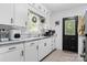 Well-lit kitchen featuring white cabinetry, stainless sink, and ample counter space at 1211 11Th Nw St, Hickory, NC 28601