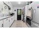 Bright kitchen featuring white cabinets, stainless steel appliances, and a large window at 1211 11Th Nw St, Hickory, NC 28601