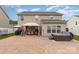 Spacious backyard with a brick patio, gazebo, hot tub, and well-maintained landscaping at 12822 Plumleaf Dr, Charlotte, NC 28213