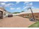 Paver patio features a hot tub, basketball hoop, and landscaping with retaining wall, perfect for outdoor activities at 12822 Plumleaf Dr, Charlotte, NC 28213