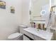 Stylish half bathroom features modern fixtures, lighted mirror, and marble accents at 12822 Plumleaf Dr, Charlotte, NC 28213