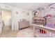 Charming bedroom with playful unicorn accents, carpet, and an adjacent doorway leading to the hall at 12822 Plumleaf Dr, Charlotte, NC 28213