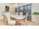 Formal dining room featuring a marble table, chandelier, and decorative curtains at 12822 Plumleaf Dr, Charlotte, NC 28213