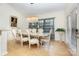 Formal dining room featuring a marble table, chandelier, and decorative curtains at 12822 Plumleaf Dr, Charlotte, NC 28213