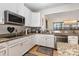Updated kitchen with granite countertops, white cabinetry, and stainless steel appliances at 12822 Plumleaf Dr, Charlotte, NC 28213