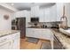 Updated kitchen with granite countertops, white cabinetry, and stainless steel appliances at 12822 Plumleaf Dr, Charlotte, NC 28213
