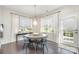 Cozy dining area with round table, chairs, and ample natural light from surrounding windows at 13338 Blanton Dr, Huntersville, NC 28078