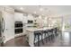 Bright, open kitchen with stainless steel appliances, a large island, and sleek white cabinetry at 13338 Blanton Dr, Huntersville, NC 28078