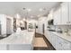 Bright white kitchen boasts an oversized island with quartz countertops and stainless steel appliances at 13338 Blanton Dr, Huntersville, NC 28078