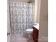 Full bathroom featuring a shower with curtain, toilet, and cabinet storage at 15494 Donnington Dr, Charlotte, NC 28277