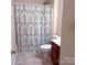 Well-lit bathroom with a shower, decorative shower curtain, and classic vanity at 15494 Donnington Dr, Charlotte, NC 28277