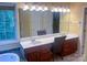 Spacious bathroom with dual sinks, vanity, and a large mirror, creating a practical and elegant space at 15494 Donnington Dr, Charlotte, NC 28277