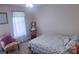 Bright bedroom with a decorative chair and a bed with a floral patterned comforter at 15494 Donnington Dr, Charlotte, NC 28277