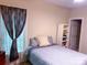 Cozy bedroom featuring a comfortable bed, stylish window treatments, and bright natural light at 15494 Donnington Dr, Charlotte, NC 28277