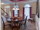 Elegant dining room with a round table, chandelier, and large windows for natural light at 15494 Donnington Dr, Charlotte, NC 28277