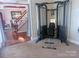 Home gym area with cable machine, bench, and view into the elegant dining room at 15494 Donnington Dr, Charlotte, NC 28277