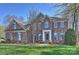 Charming two-story brick home with a manicured lawn and inviting front entrance at 15494 Donnington Dr, Charlotte, NC 28277