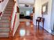 Elegant foyer with hardwood floors, staircase, and decorative accents leading to a cozy living area at 15494 Donnington Dr, Charlotte, NC 28277