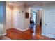 Inviting hallway with hardwood floors and neutral walls, leading to various rooms at 15494 Donnington Dr, Charlotte, NC 28277