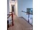 Upstairs hallway with carpet, white railings, and a view of artwork, creating an inviting atmosphere at 15494 Donnington Dr, Charlotte, NC 28277